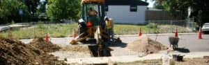 men working on a water line excavation